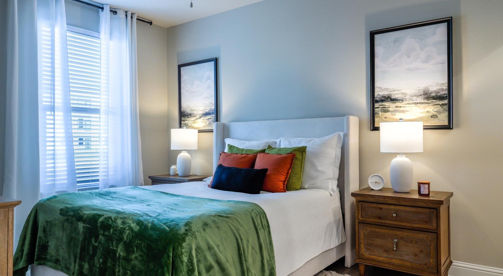 Beautiful bedrooms to fit every need a bedroom with a bed and lamps and a large window