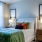 a bedroom with a bed and lamps and a large window