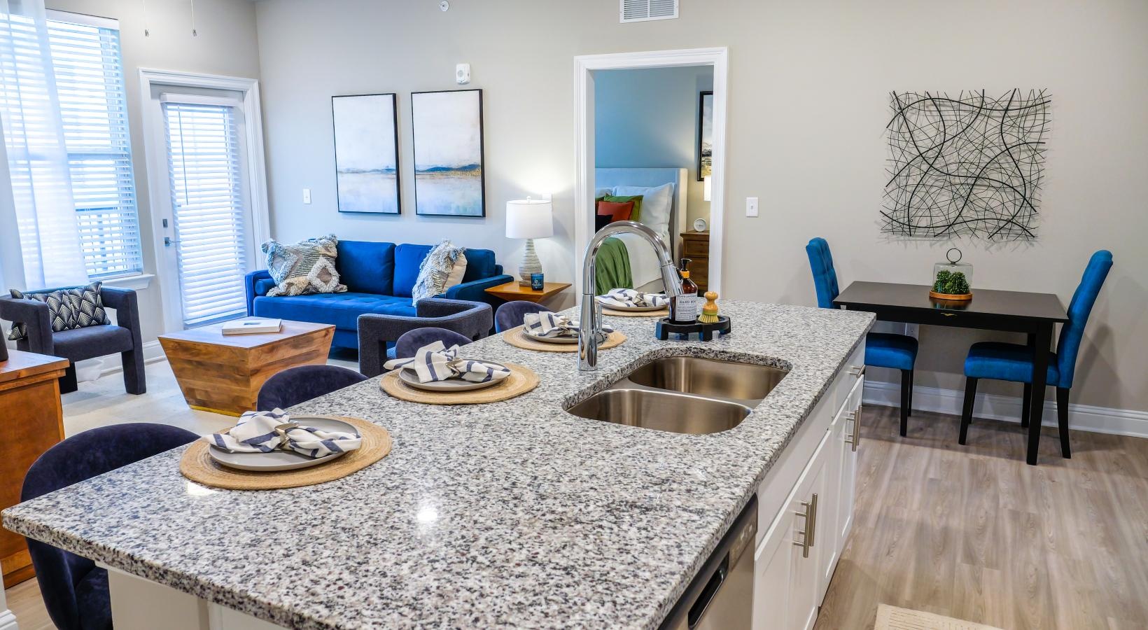 Wide open living areas perfect for entertaining a kitchen island with a sink and chair
