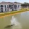 a building with a fountain in a pond in the front