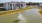 a building with a fountain in a pond in the front