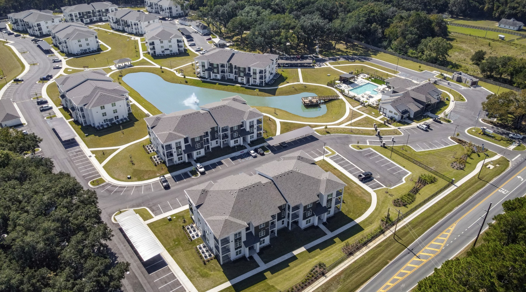 Arial view of Flats at East Bay buildings and lake in Fairhope, AL