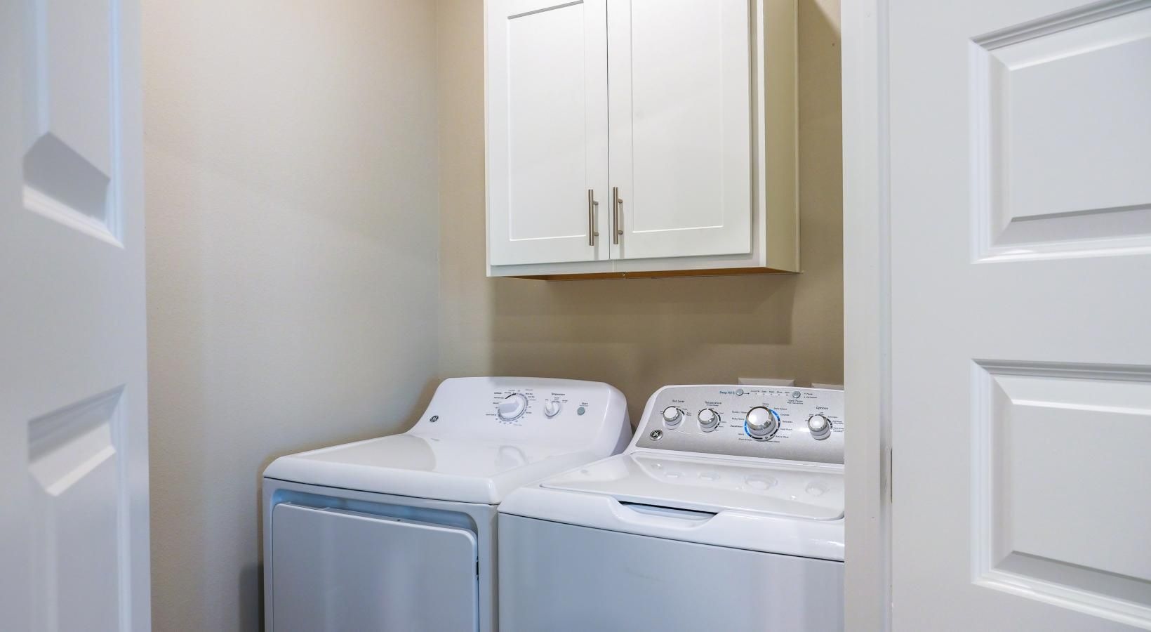 Washers and dryers available a white washing machine in a closet