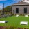a backyard with cornhole and chairs