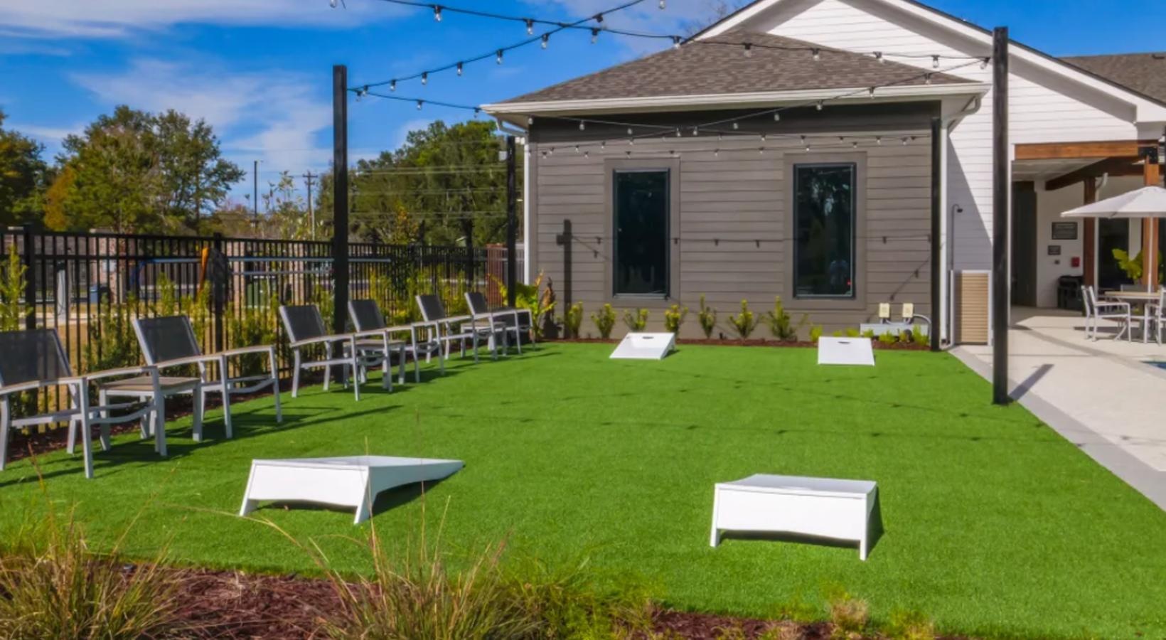 The essence of exceptional living a backyard with cornhole and chairs