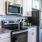 a kitchen with white cabinets a stovetop a fridge