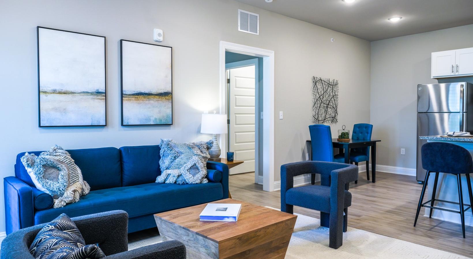 Generous living spaces to relax and unwind a living room with blue couches and a coffeetable