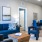 a living room with blue couches and a coffeetable