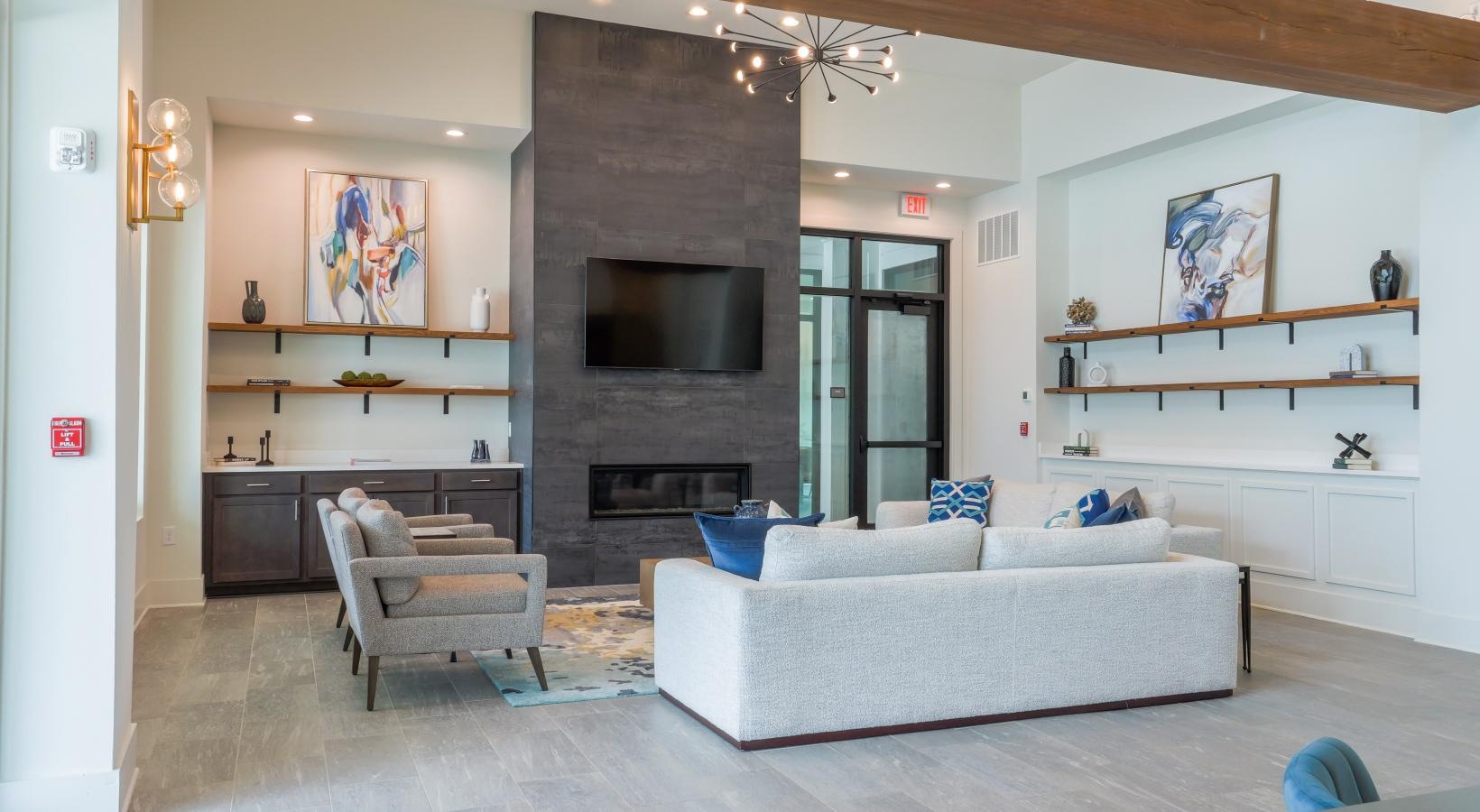 Access to resident-only features a lounge room with a fireplace and couch and chairs