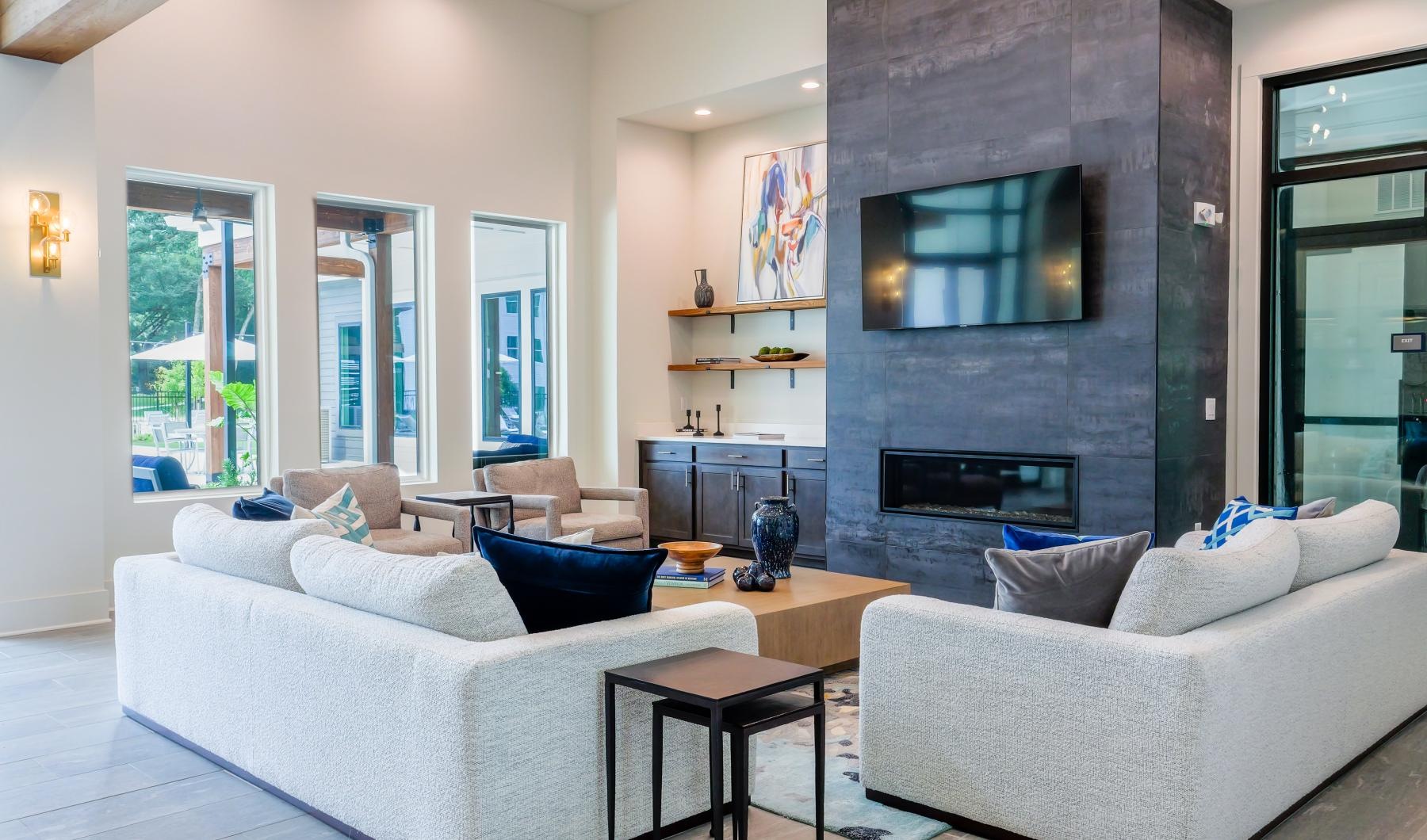 Settle into comfort at The Flats at East Bay a lounge room with a fireplace couches and a tv
