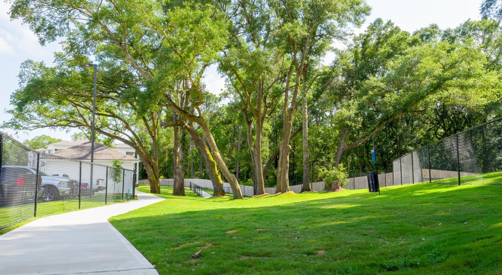Find your perfect fit at The Flats at East Bay a sidewalk and grass with trees