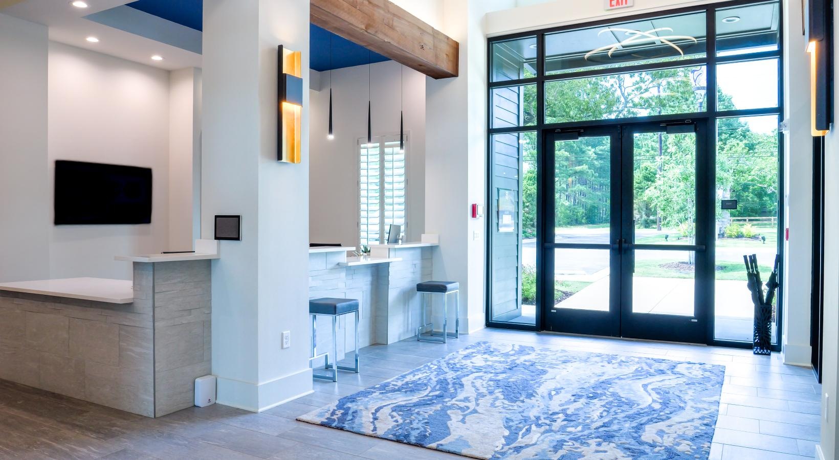 Everything within reach a lobby with a rug and a table and a tv