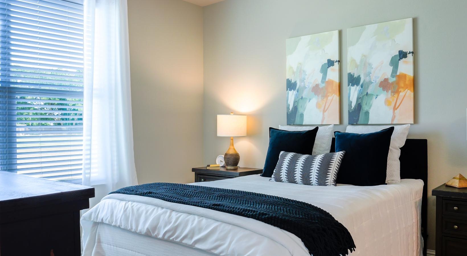 Relax and recharge in beautiful and spacious bedrooms a bed with a white bed spread and a large window