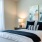 a bed with a white bed spread and a large window