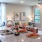 a kitchen island with chairs and with a living room behind it
