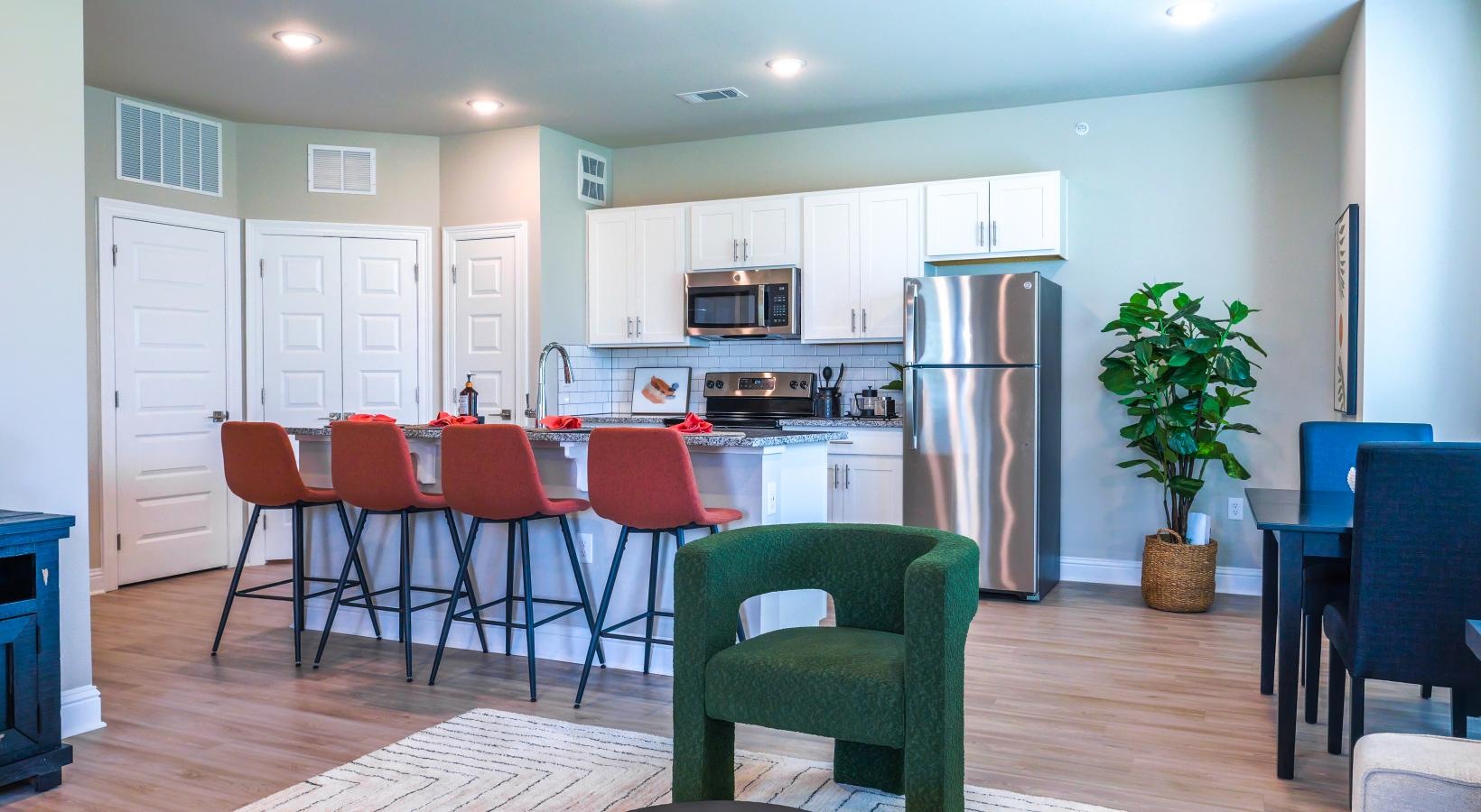 Relax and unwind in stylish living spaces a kitchen island and a dining table and chairs